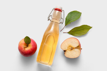 Bottle of fresh apple cider and fruits on white background