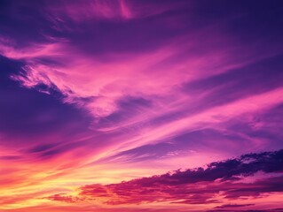 Fototapeta premium A breathtaking view of a vibrant purple sunset sky with wispy clouds, perfect for nature and landscape photography.