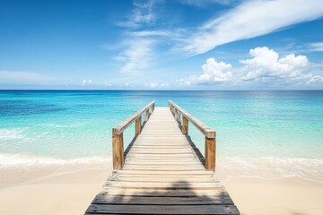 Wooden pier extending into turquoise ocean with white sand beach and clear water in a wide-angle view.
