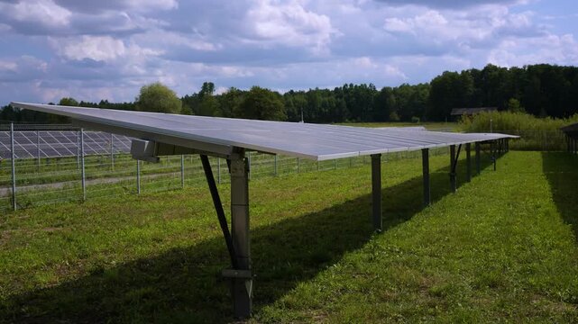 Solar panels with active tracker. PV panels tracking sun timelapse. Modern technology, renevable energy, solar panels moving towards sun, rural landscape
