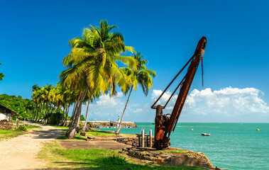 Old rusty port crane at a former penal colony on Ile Royale, the Salvation Islands in French...