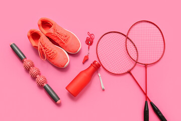 Sneakers and sports equipment on pink background