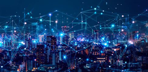 City skyline illuminated at night with a network of digital connections overlaid