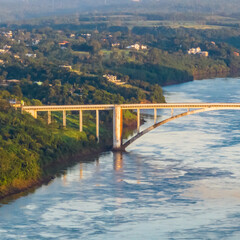 Obraz premium Border between Brazil and Paraguay and connects Foz do Iguacu to Ciudad del Este. Ponte da Amizade in Foz do Iguacu. Aerial view of the Friendship Bridge with Parana river.
