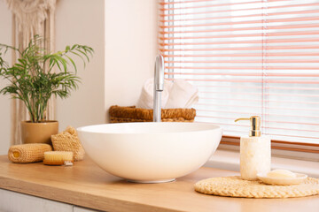 Sink, soap and sponges in interior of bathroom