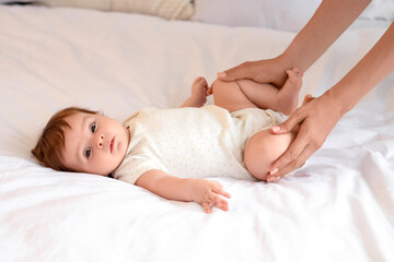 Cute little baby getting massage on bed