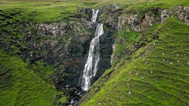 Aerial view of Scottish highlands falls in Scotland. Waterfall landscape in the United Kingdom. Scenic drone view of waterfalls on the Isle of Skye.