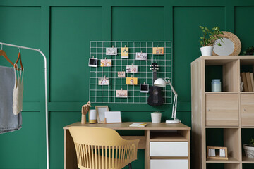 Interior of office with workplace, mood board and ukulele