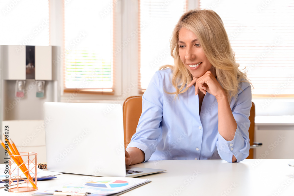 Poster beautiful businesswoman working with laptop at table in office