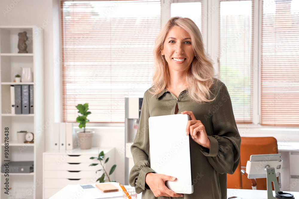 Wall mural beautiful businesswoman with laptop in office