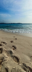 Johnny Cay Beach, San Andres Islands footprints of a person on the sand in front of the sea