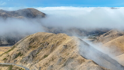 Aerial view of the mountains shrouded in cloud in Torlesse Tussocklands Park