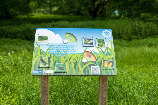 An educational signboard in a lush green park in Chalette-sur-Loing, France, highlighting the importance of biodiversity and the small creatures that contribute to it