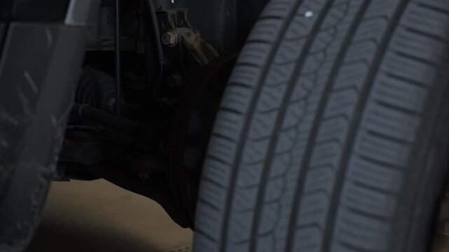 Auto mechanic removing tire to replacing brake on a vehicle,