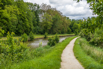 Serene Canal Pathway Surrounded by Lush Greenery
