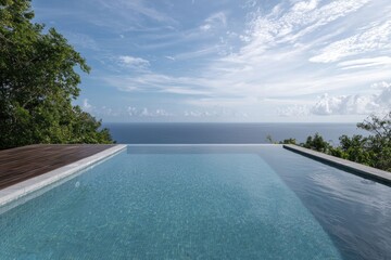 Fototapeta premium A stunning view from a private villa overlooking the ocean, featuring an infinity pool and breathtaking sunset