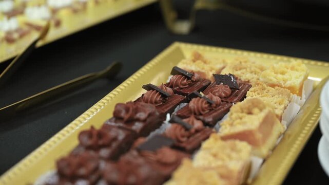Candy bar, Sweets on stands. Delicious desserts at the banquet, sponge cakes, shortbread tarts. Close up view move camera