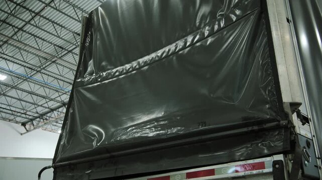 Open Conestoga type Trailer in warehouse. Wide view