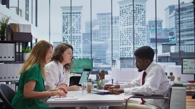 Job candidate in wheelchair signing a new employment contract after the successful interview, HR employees making him feel lucky and finally experience acceptance despite his disability. Camera B.