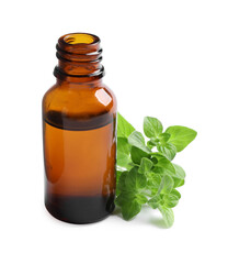 Essential oil in bottle and oregano leaves isolated on white
