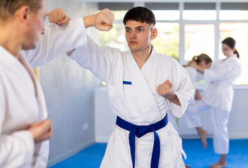 Athletes sparring during karate classes in the gym