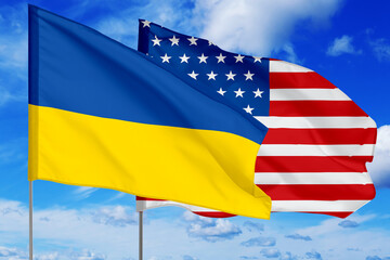 Flags of Ukraine and USA against sky. Diplomatic international relations
