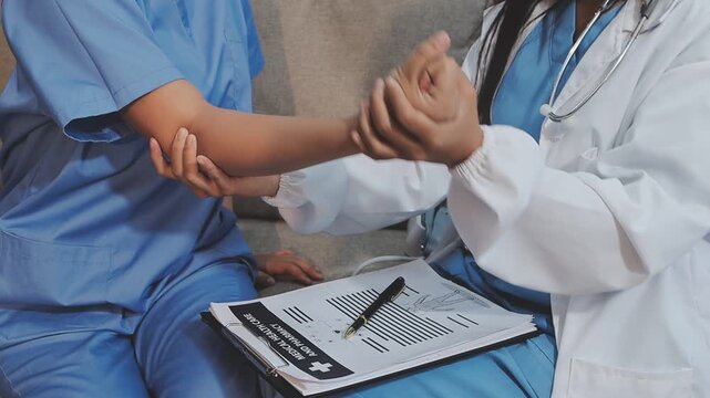 Physical therapist working with patient on arm exercises in rehab, focusing on recovery and improvement in a clinic setting.