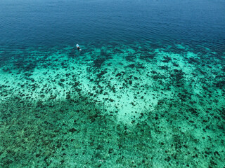Aerial view of coral reef on Koh Phi Phi Don, in Krabi. Phi Phi islands is one of the top tourist destinations in Thailand. The picture shows the intense turquoise water and the blue navy water color