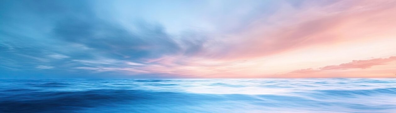 Serene seascape with soft waves beneath a gradient sky, transitioning from blue to pink hues at sunset, evoking tranquility and peace.