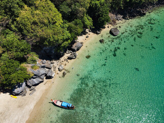 Aerial view of long tail boat on the Sabai beach of the ko Muk island in the province of Trang, Thailand, this exclusive beach is famous for its white sand, turquoise water and limestone mountains
