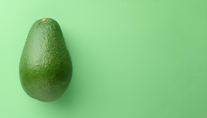 One fresh avocado. green background - avocado pear, alligator pear, Persea americana