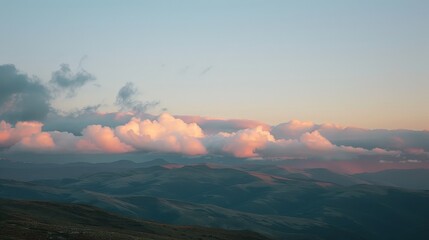 High-altitude clouds catch the last light of the setting sun, glowing softly