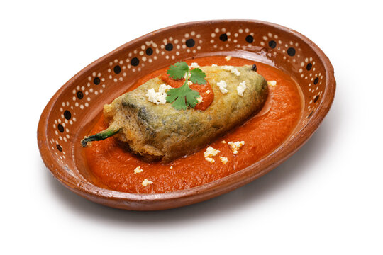 chile relleno (fried poblano pepper stuffed with minced meat and coated with egg meringue), Mexican cuisine isolated on white background