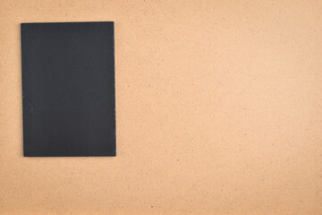 Fototapeta premium blank black notebook on brown wood texture background