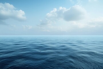 Obraz premium A serene view of a calm sea under a blue sky filled with soft clouds, ideal for serene backgrounds and nature-themed designs.