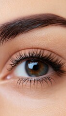 Fototapeta premium Close-up of an eye showcasing beautiful eyelashes and natural skin tones, highlighting details of vision and beauty.