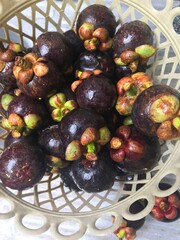Mangosteen is another popular fruit in Thailand. It has a hard purple skin and white flesh that is soft and sweet. It has brown seeds.