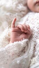 Newborn Baby Hand Wrapped in White Lace Fabric