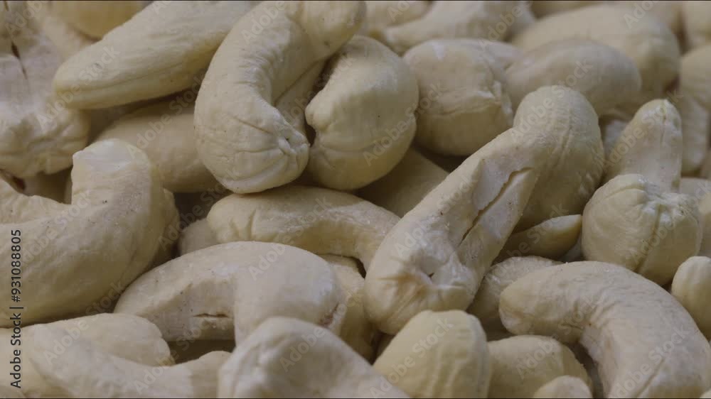 Poster macro close up shot of portion of cashew nuts and more being placed. static