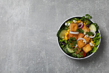 Fried tofu salad in a bowl, top view