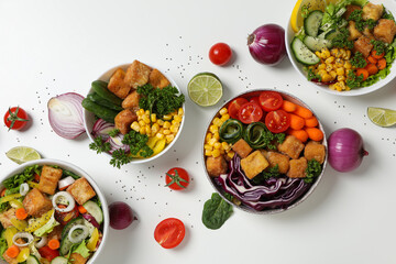 Fried tofu salad with vegetables on a light background