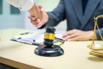 A lawyer is seated at a desk in an office, reviewing and signing legal documents. The scene captures a professional setting focused on contracts, finance,  providing legal advice to clients.