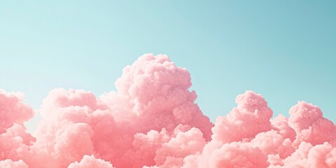Soft, dreamy pink clouds resembling cotton candy in a clear sky, evoking a feeling of whimsy and fantasy. 