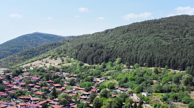 Forest hillside remote Balkan village Zheravna Bulgaria, drone shot