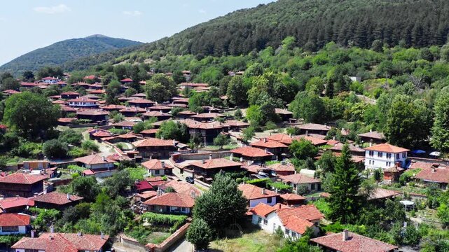 Red rooftops of Zheravna remote Balkan mountain village Bulgaria Drone shot