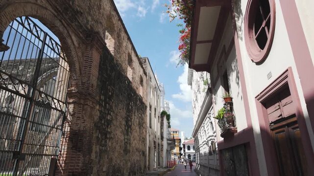 People stroll through a charming narrow street in Casco Viejo, Panama City's historic district