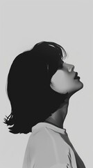 Fototapeta premium Side profile of a woman with short hair looking up.