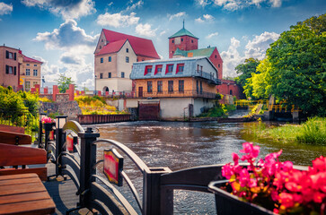 Astonishing summer view of Castle of the Dukes of Pomerania with blooming flowers in the pots. Beautiful morning cityscape of Darlowo town, Poland, Europe. Traveling concept background..