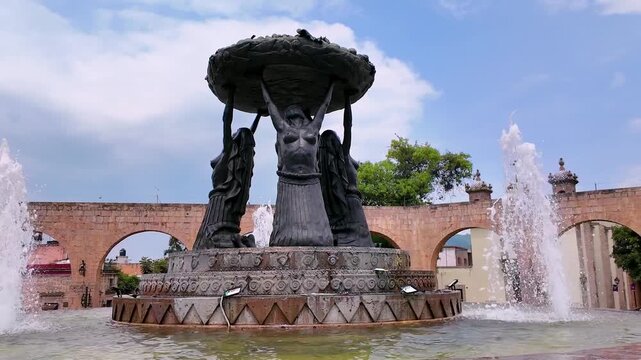 The majestic sculpture of the fountain of Las Tarascas, symbol of fertility, stands in the middle of a vehicular traffic circle in the city of Morelia, Michoacan.