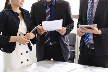 Group of asian young business partners talking and sharing ideas in the meeting.